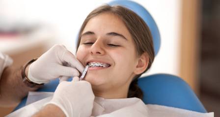 Teenage girl on dental clinic for her braces appointment
